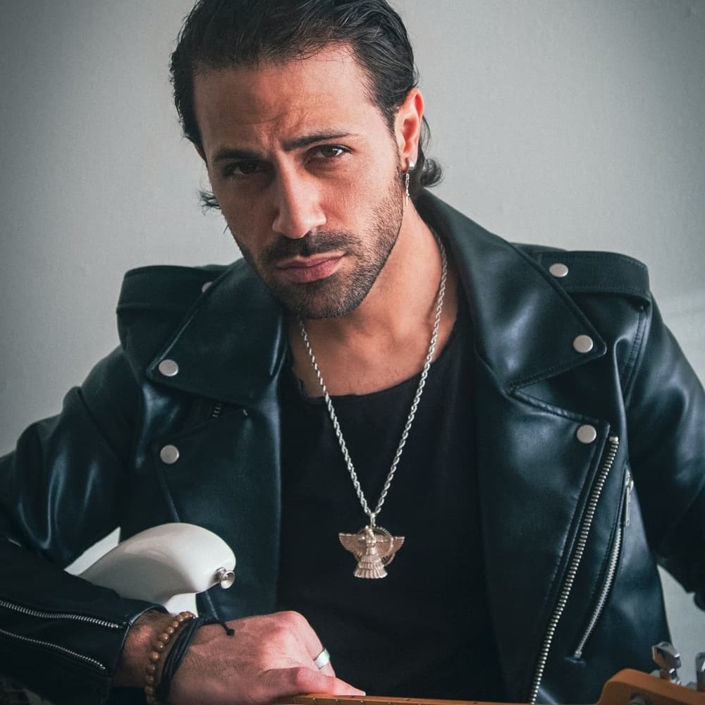 Man wearing the lamassu pendant necklace under an open jacket
